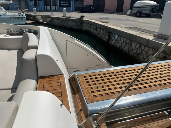 Azimut Benetti Fly 50 Yacht Photos Pics Luxury Azimut 50 yacht deck with wooden accents, docked at a marina.