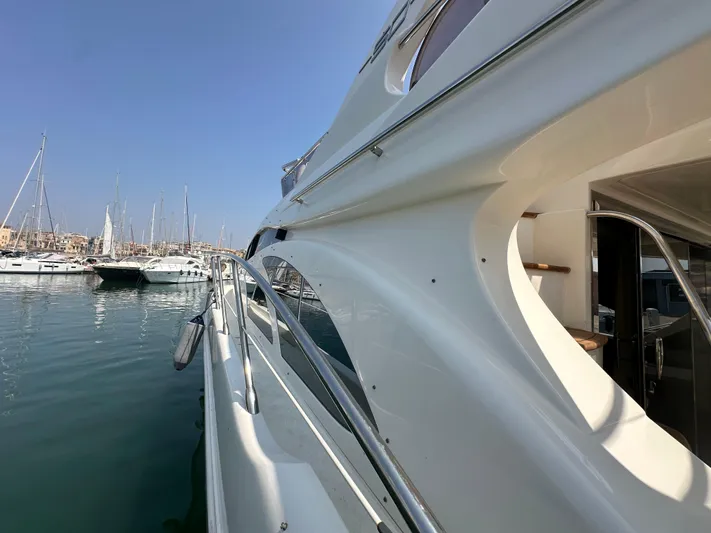 Azimut Benetti Fly 50 Yacht Photos Pics 2006 Azimut 50 yacht docked in a marina, showcasing sleek design and luxury features.