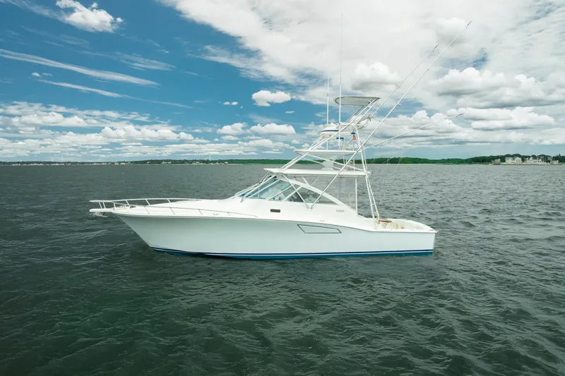 King's Ransom Yacht Photos Pics 2004 Cabo 40 Express yacht on open water under a partly cloudy sky.