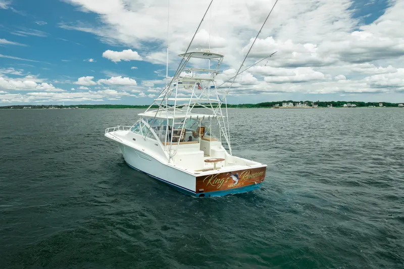 King's Ransom Yacht Photos Pics 2004 Cabo 40 Express boat on open water under a partly cloudy sky.