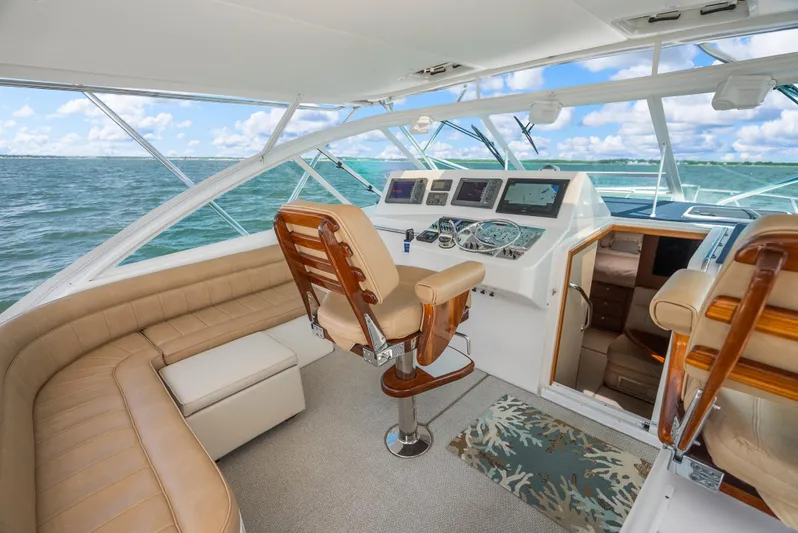 King's Ransom Yacht Photos Pics Luxurious 2004 Cabo 40 Express yacht interior with helm, leather seating, and ocean view.