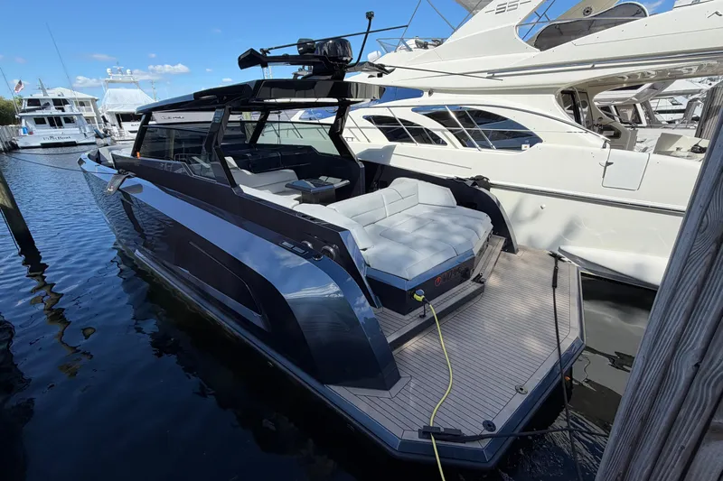  Yacht Photos Pics 2022 Vanquish VQ45 luxury yacht docked at marina, showcasing sleek design and spacious deck.