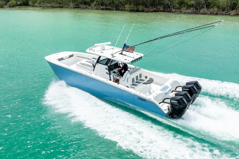 Kroppdustr Yacht Photos Pics 2023 Invincible 37 Catamaran cruising on turquoise water with four outboard engines.