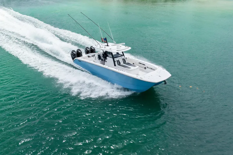 Kroppdustr Yacht Photos Pics 2023 Invincible 37 Catamaran cruising on turquoise waters, showcasing sleek design and powerful engines.