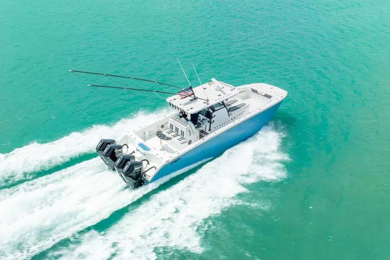 Kroppdustr Yacht Photos Pics 2023 Invincible 37 Catamaran cruising on turquoise waters, showcasing powerful engines.