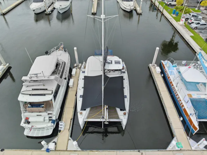 Neptune's Waters Yacht Photos Pics Aerial view of a 2019 Lagoon 42 yacht docked in a marina.