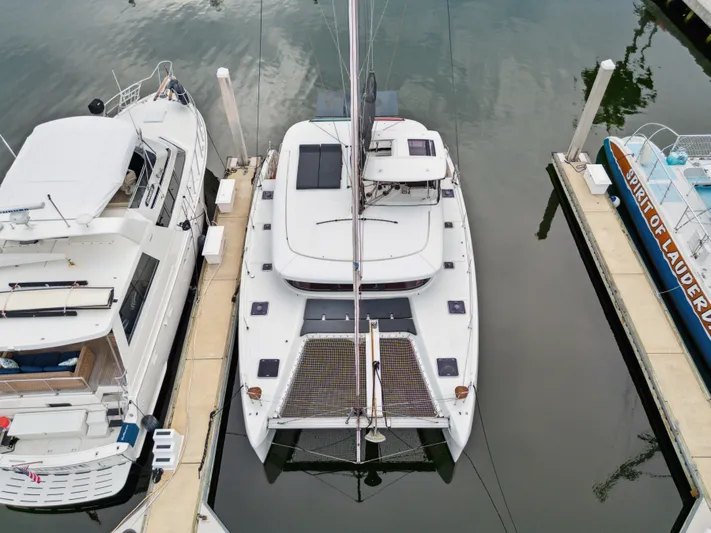 Neptune's Waters Yacht Photos Pics Aerial view of a 2019 Lagoon 42 yacht docked in a marina.