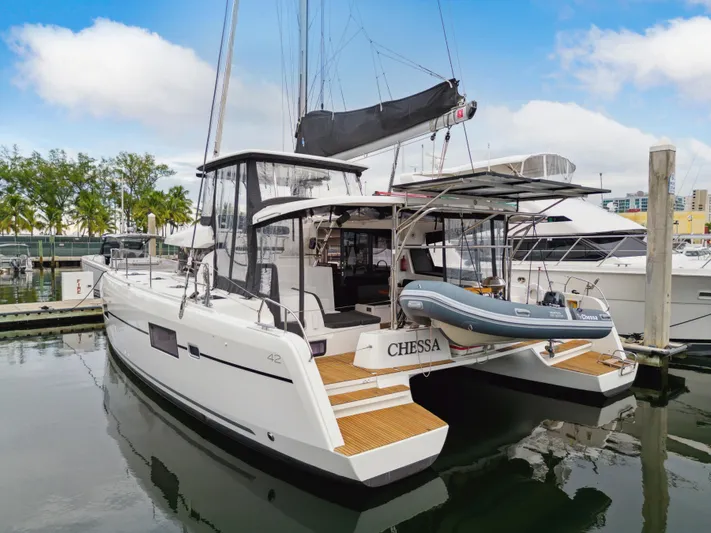 Neptune's Waters Yacht Photos Pics 2019 Lagoon 42 catamaran docked with dinghy.