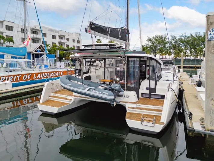 Neptune's Waters Yacht Photos Pics 2019 Lagoon 42 catamaran docked with dinghy.