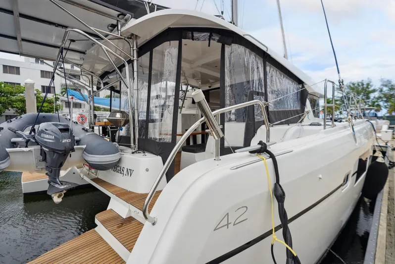 Neptune's Waters Yacht Photos Pics 2019 Lagoon 42 catamaran docked with outboard motor.