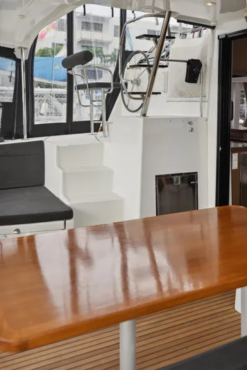 Neptune's Waters Yacht Photos Pics Interior of a 2019 Lagoon 42 yacht with wooden table.