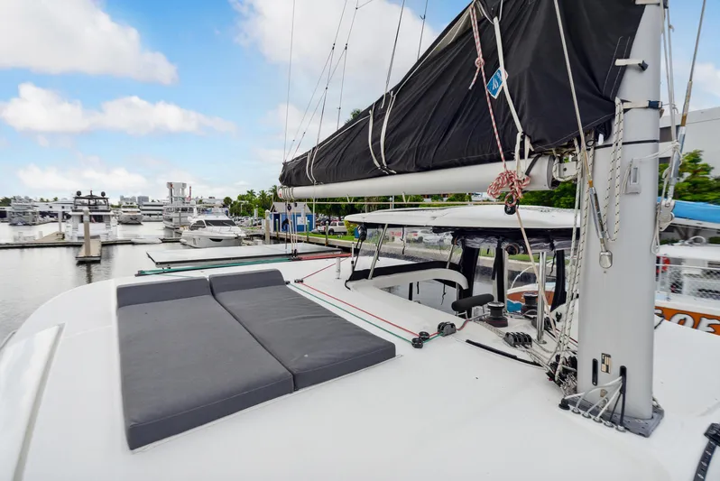 Neptune's Waters Yacht Photos Pics 2019 Lagoon 42 catamaran docked with sail and lounging area.