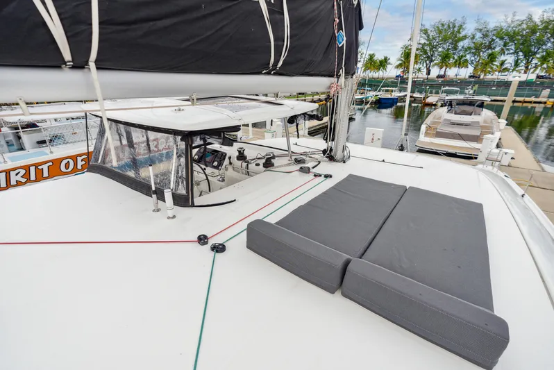 Neptune's Waters Yacht Photos Pics 2019 Lagoon 42 catamaran with lounging area and helm station in harbor.