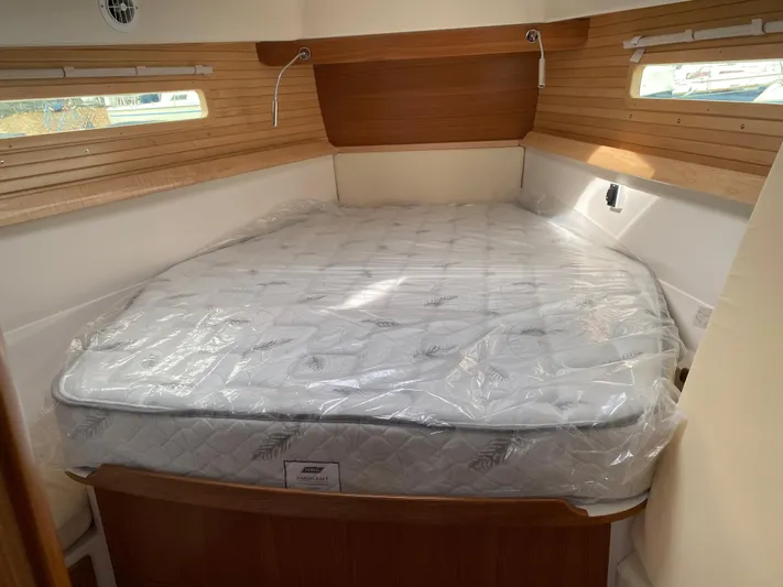 Catalina 425 In Stock Yacht Photos Pics 2024 Catalina 425 cabin interior with a neatly made bed and wooden accents.