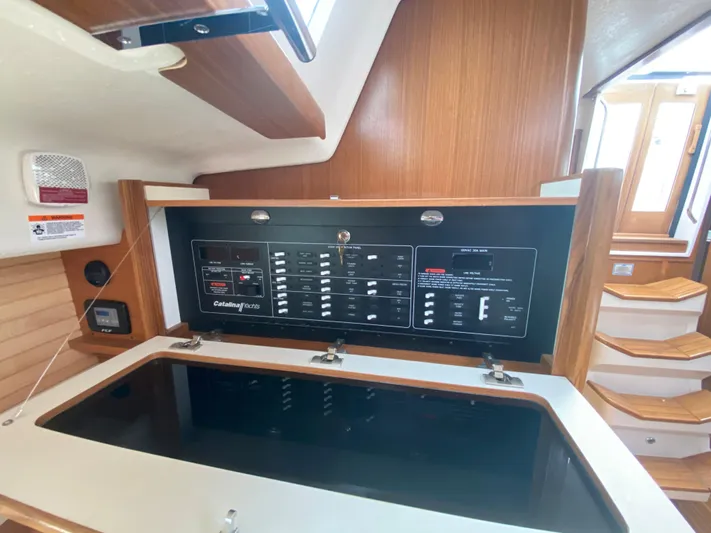Catalina 425 In Stock Yacht Photos Pics 2024 Catalina 425 yacht interior with control panel and wooden staircase.