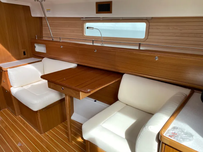 Catalina 425 In Stock Yacht Photos Pics 2024 Catalina 425 yacht interior with wooden finish and white cushioned seating.