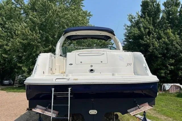  Yacht Photos Pics 2005 Sea Ray 390 Sundancer yacht, rear view, parked on land with trees in background.