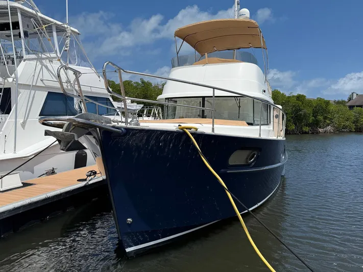 Wanderer Yacht Photos Pics 2016 Beneteau Swift Trawler 44 docked, featuring a sleek blue hull and spacious deck.