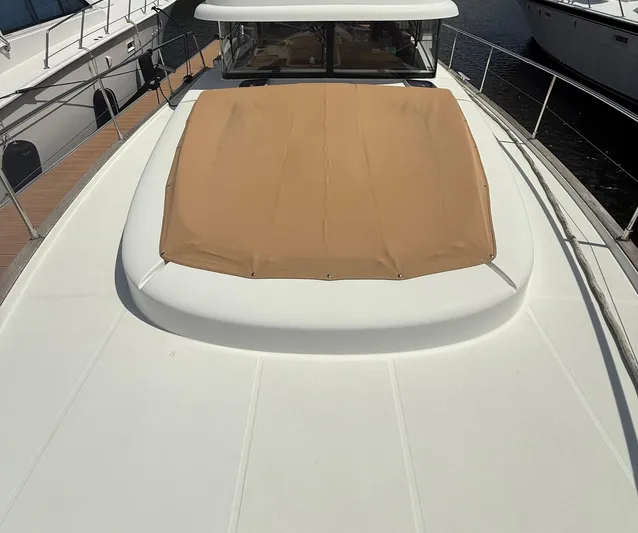 Wanderer Yacht Photos Pics 2016 Beneteau Swift Trawler 44 with tan sunpad on deck, docked at marina.