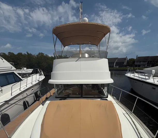 Wanderer Yacht Photos Pics 2016 Beneteau Swift Trawler 44 docked, featuring a spacious deck and flybridge under a clear sky.