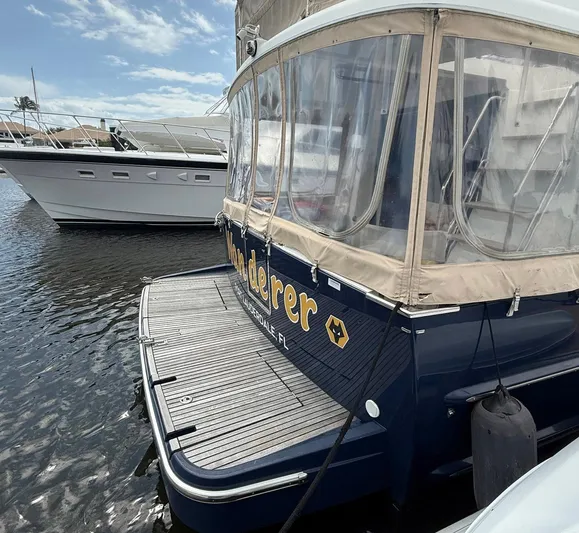 Wanderer Yacht Photos Pics 2016 Beneteau Swift Trawler 44 docked, featuring rear deck and protective canopy.