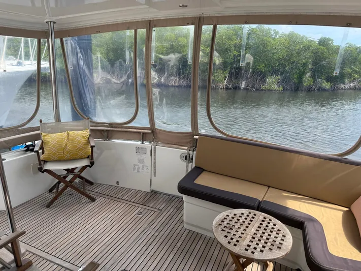 Wanderer Yacht Photos Pics 2016 Beneteau Swift Trawler 44 interior with seating, table, and river view.