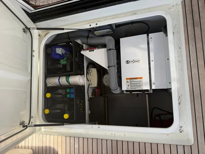 Wanderer Yacht Photos Pics Engine compartment of a 2016 Beneteau Swift Trawler 44, showing equipment and storage.