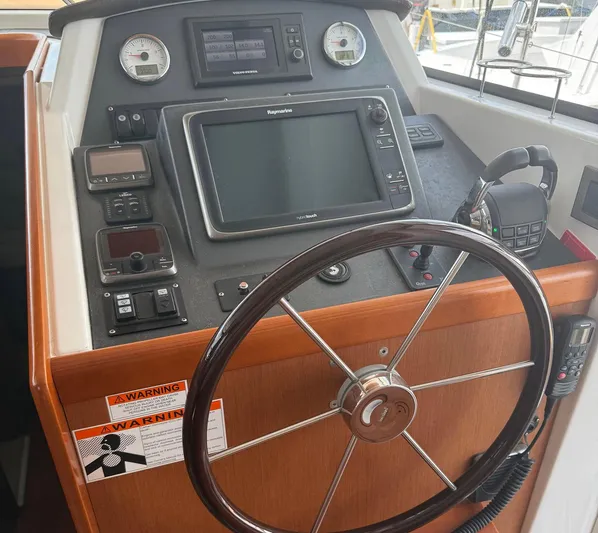 Wanderer Yacht Photos Pics Steering console of 2016 Beneteau Swift Trawler 44 with navigation equipment and controls.