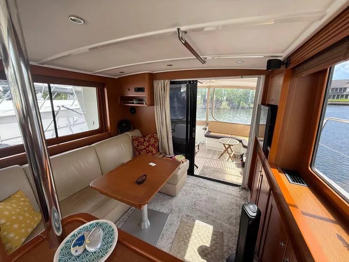 Wanderer Yacht Photos Pics Interior of 2016 Beneteau Swift Trawler 44 with cozy seating and outdoor view.