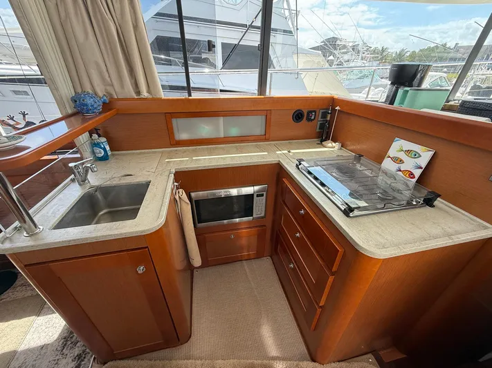 Wanderer Yacht Photos Pics 2016 Beneteau Swift Trawler 44 kitchen with sink, stove, and microwave.