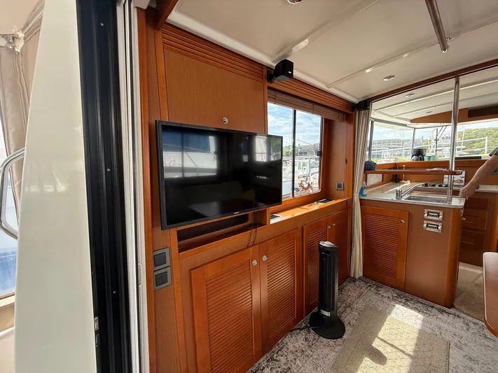 Wanderer Yacht Photos Pics Interior of 2016 Beneteau Swift Trawler 44 with TV and kitchenette.