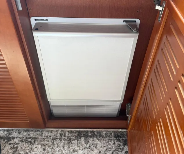 Wanderer Yacht Photos Pics Built-in cabinet on 2016 Beneteau Swift Trawler 44, featuring wooden finish and compact design.