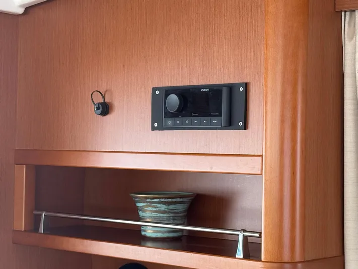 Wanderer Yacht Photos Pics Wooden interior of 2016 Beneteau Swift Trawler 44 with stereo system and decorative bowl.
