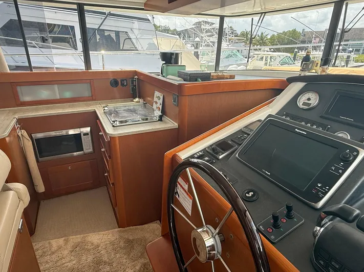 Wanderer Yacht Photos Pics 2016 Beneteau Swift Trawler 44 helm with navigation controls and compact kitchen area.