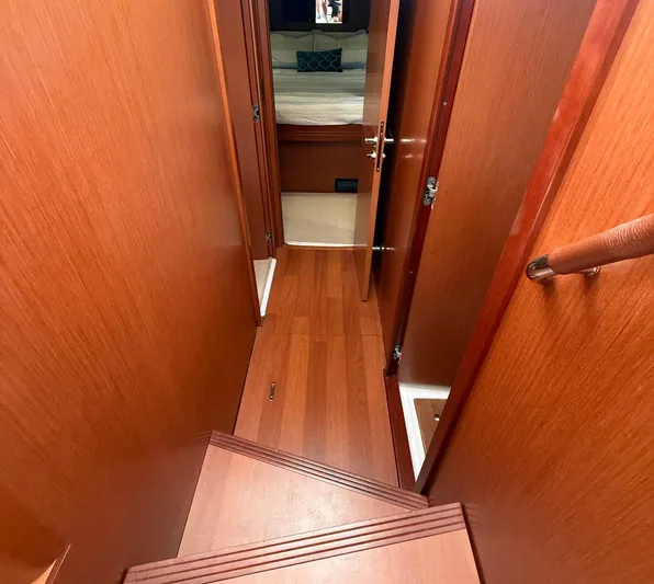 Wanderer Yacht Photos Pics Interior view of 2016 Beneteau Swift Trawler 44, featuring wooden stairs and hallway.