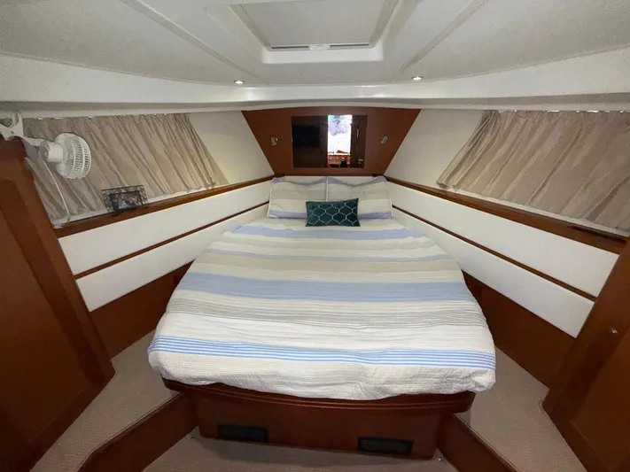 Wanderer Yacht Photos Pics 2016 Beneteau Swift Trawler 44 cabin with cozy bed and striped bedding.