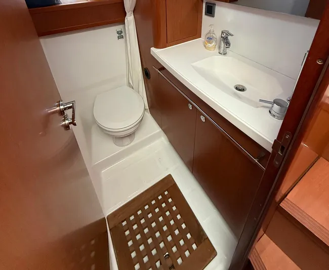 Wanderer Yacht Photos Pics 2016 Beneteau Swift Trawler 44 bathroom with toilet, sink, and wooden floor mat.