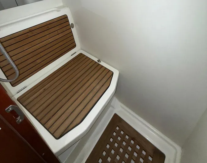 Wanderer Yacht Photos Pics 2016 Beneteau Swift Trawler 44 shower area with wooden seating and flooring.