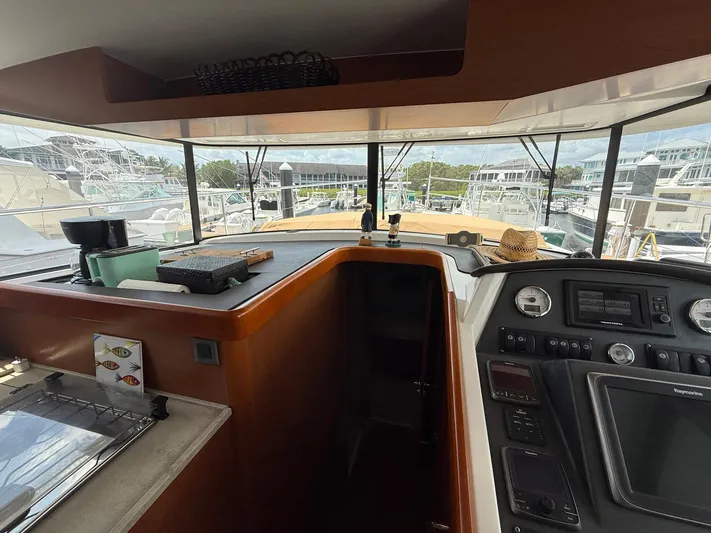 Wanderer Yacht Photos Pics 2016 Beneteau Swift Trawler 44 interior with helm, dashboard, and marina view.
