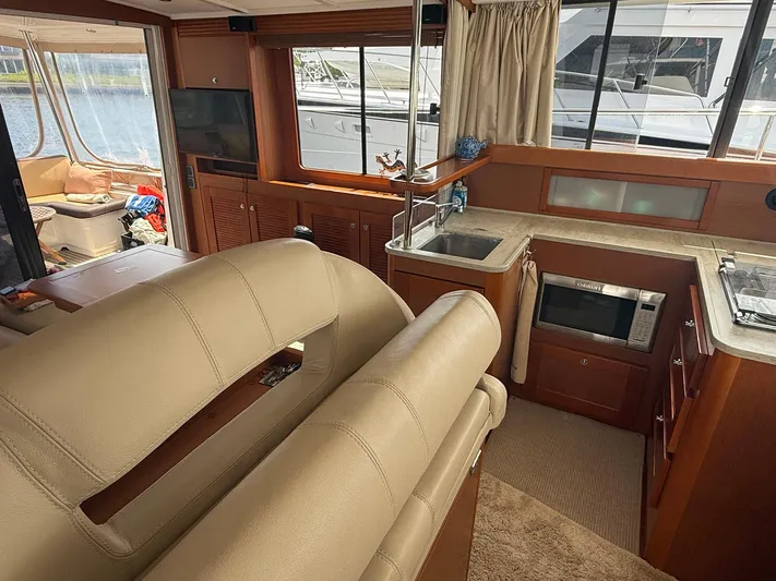 Wanderer Yacht Photos Pics Interior of 2016 Beneteau Swift Trawler 44 with kitchen and seating area.