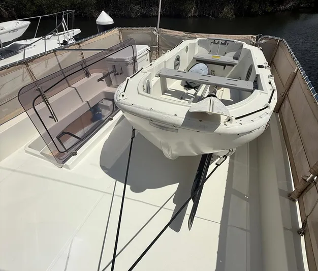 Wanderer Yacht Photos Pics 2016 Beneteau Swift Trawler 44 deck with dinghy and seating area.