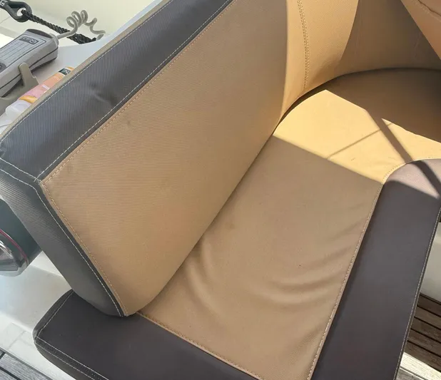 Wanderer Yacht Photos Pics Cushioned seating on 2016 Beneteau Swift Trawler 44, featuring beige and brown upholstery.