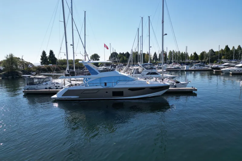  Yacht Photos Pics 2024 Azimut Fly 60 yacht docked in a serene marina setting.