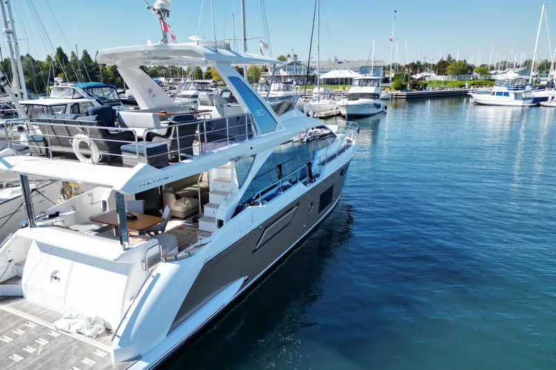  Yacht Photos Pics 2024 Azimut Fly 60 yacht docked in a marina, showcasing luxury design and spacious decks.