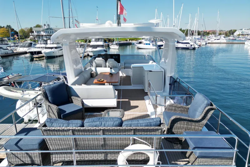  Yacht Photos Pics Luxurious 2024 Azimut Fly 60 yacht with elegant outdoor seating at marina.