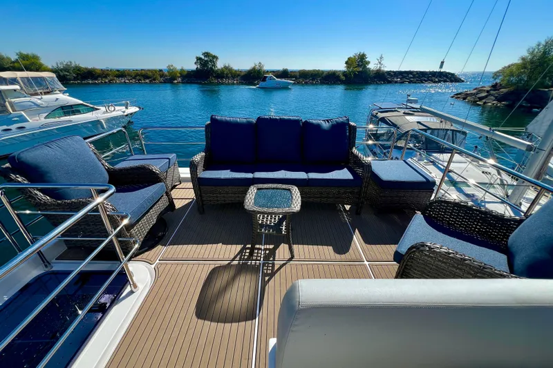  Yacht Photos Pics Luxurious seating area on 2024 Azimut Fly 60 yacht, docked by serene waters.