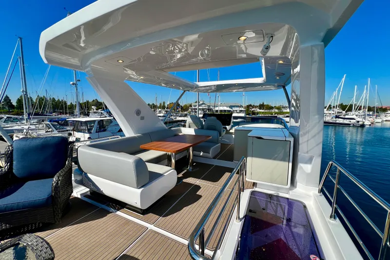  Yacht Photos Pics Luxurious 2024 Azimut Fly 60 yacht deck with elegant seating and marina view.