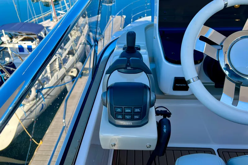  Yacht Photos Pics 2024 Azimut Fly 60 yacht helm with steering wheel and control panel.