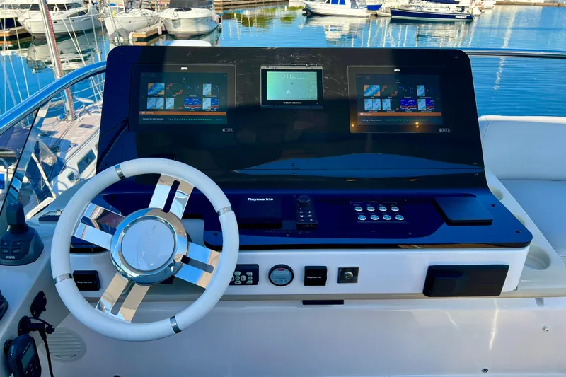  Yacht Photos Pics 2024 Azimut Fly 60 yacht helm with advanced navigation displays and sleek steering wheel.