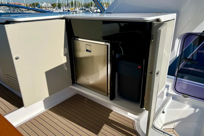  Yacht Photos Pics 2024 Azimut Fly 60 yacht interior with open cabinet and mini fridge.